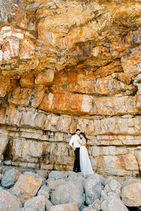 Rear view of woman standing on rock