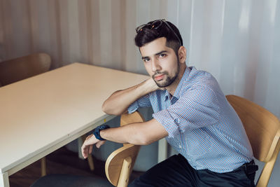 Young man sitting on chair