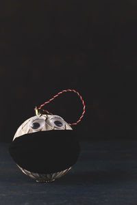 Close-up of cake on table against black background