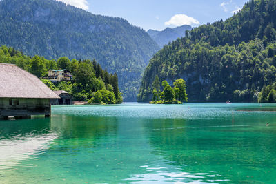 Scenic view of swimming pool by lake against mountains