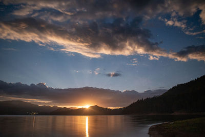 Strawberry moon rise over a mountain lake.