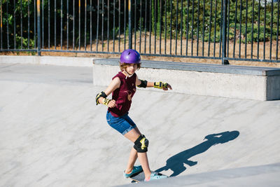 Teen girl focused as she is skateboarding at the skatepark