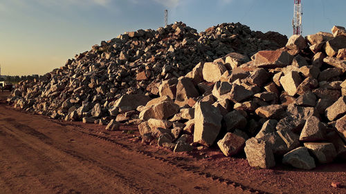 Stack of rocks on railroad track against sky