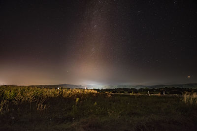 Scenic view of field against sky at night