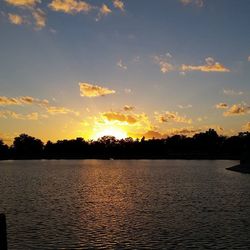 Scenic view of lake at sunset