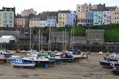 Sailboats in harbor by sea in city