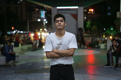 Full length of young man standing in city at night