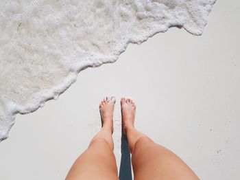 Low section of woman legs on beach