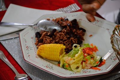 Close-up of hand holding food in plate