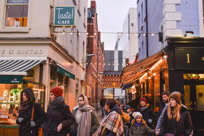 People on city street at dusk