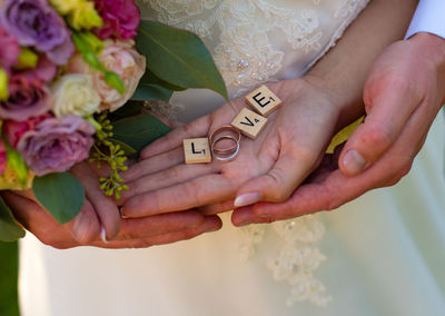 Midsection of woman holding bouquet of people