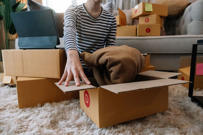 Rear view of men sitting in box at home