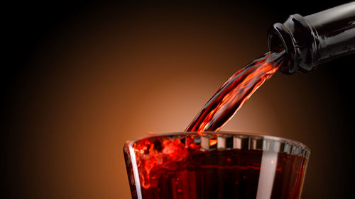 Close-up of drink pouring in glass