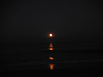 Scenic view of sea against sky at night