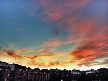 Low angle view of buildings against sky at sunset