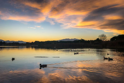 Scenic view of lake against sky during sunset