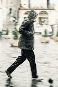 Side view of man running on street