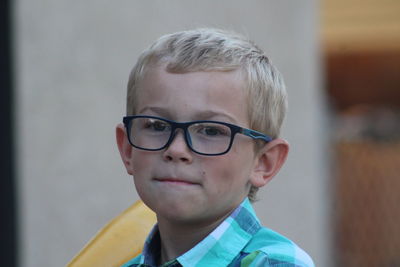 Close-up portrait of cute boy wearing eyeglasses