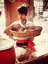 Young man eating food on table