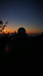 View of illuminated mountain against sky at sunset