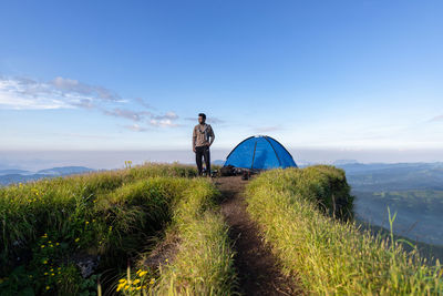 Man standing on mountain against sky