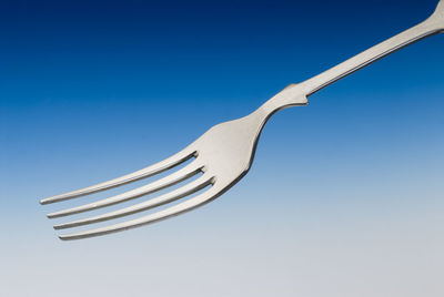 Close-up of fork against clear blue sky