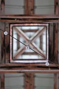 Low angle view of electric lamp hanging on ceiling in building