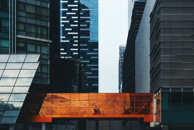 Low angle view of modern buildings in city against sky