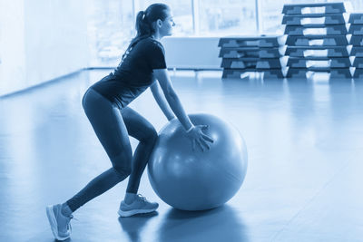 Rear view of woman exercising in gym