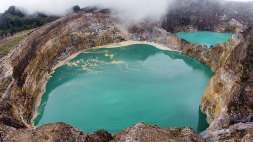 Scenic view of misty lake kelimutu in ende, flores, east nusa tenggara, indonesia