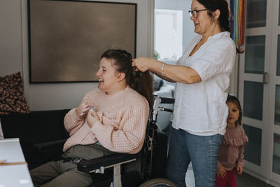 Mother braiding daughter's hair