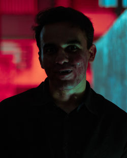 Portrait of young man as a vampire with face full of blood 