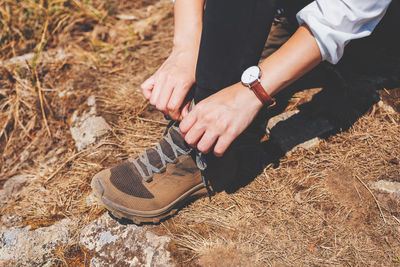 High angle view of woman tying shoelace