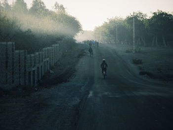 Man walking on road in foggy weather