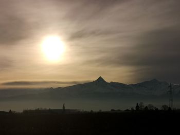 Scenic view of silhouette mountains against sky at sunset