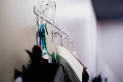 Close-up of paper hanging against wall at home