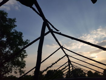 Low angle view of silhouette bridge against sky at sunset