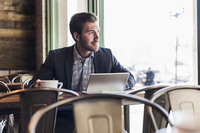 Businessman using tablet in a cafe