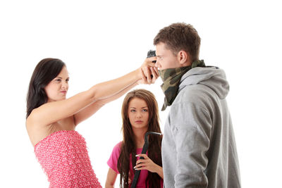 Portrait of a smiling young woman against white background