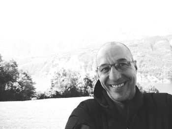 Portrait of smiling man standing on field 