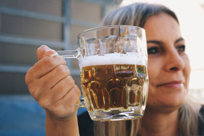 Cropped hand of woman holding drink