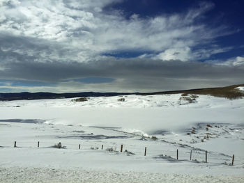 Scenic view of beach against sky during winter