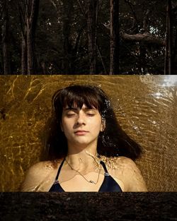 Double exposure image of woman swimming in sea and trees