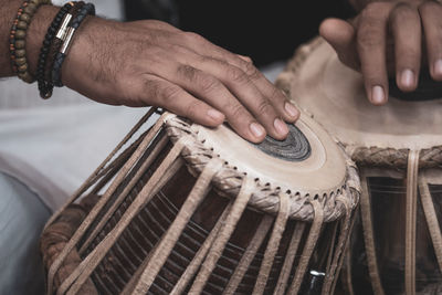 Midsection of man playing tabla