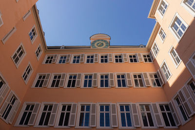 Low angle view of buildings against clear blue sky