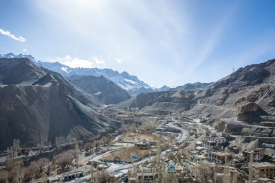 Aerial view of a valley with mountain range in background