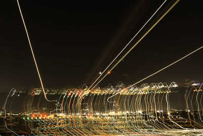 Light trails against sky at night