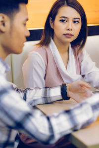 Two individual in a focused discussion about anything.