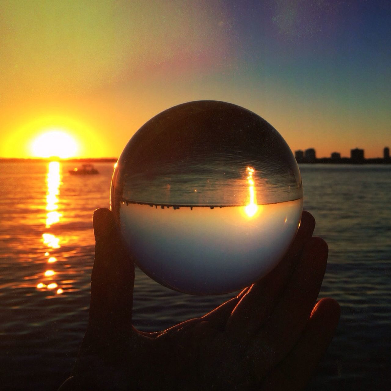 illuminated, lighting equipment, light bulb, sunset, focus on foreground, indoors, sun, glowing, close-up, electricity, orange color, sphere, electric light, lens flare, circle, silhouette, holding, electric lamp