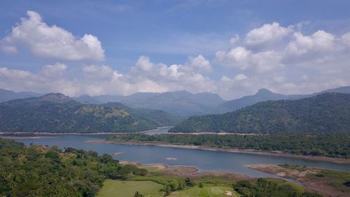 Scenic view of lake and mountains against sky